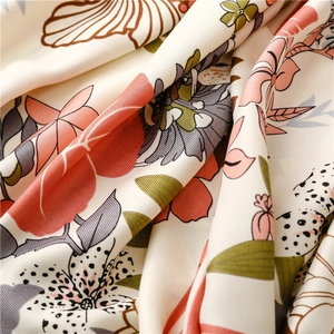Macro detail of tropical floral print scarf showing smooth twill fabric and soft drape