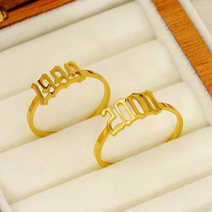 Polished 18K gold plated stainless steel rings featuring 1999 and 2000 year number designs