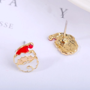 Detail view of festive Santa Claus stud earrings with red enamel and gold finish