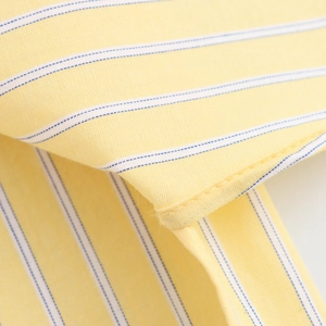 Detailed close-up of yellow and blue striped fabric texture and precision stitching