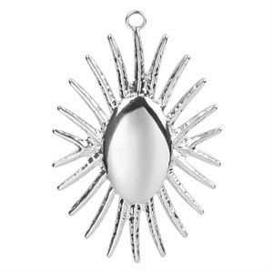 Macro detail of silver sunburst pendant featuring radiating spikes and polished oval center
