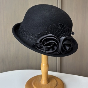 Elegant vintage black wool cloche hat with satin roses and delicate mesh veil decoration