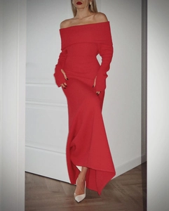 Detail of red off-shoulder knitted dress showing the elegant neckline and fabric texture