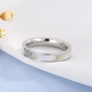 Detailed shot of CNC shell inlay with three crystals on silver stainless steel ring