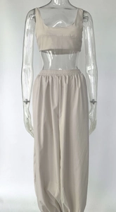 Detail of beige two-piece lounge set with cropped tank top and elastic waist pants