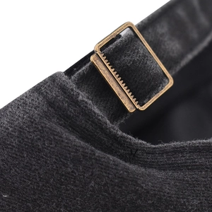 Detail of vintage bronze metal buckle and washed gray fabric on baseball cap back