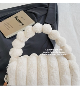 Detail of white plush faux fur handbag with unique fluffy pom-pom beaded handle design