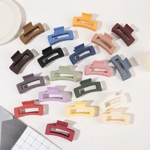 Detailed flat lay of rectangular matte hair clips in various vibrant colors with metal springs