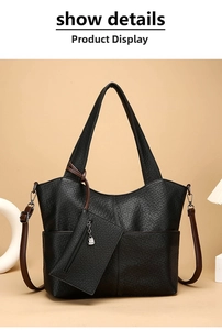 Detail of black elephant grain tote bag with brown straps and matching coin purse