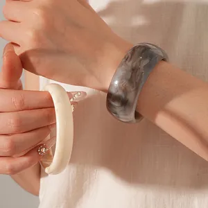 Fashionable thick resin bangles with cream and grey marble swirl textures for women
