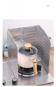 Three-sided folding aluminum foil splatter guard protecting kitchen walls from grease stains