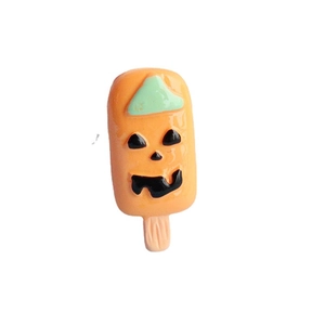 DIY orange pumpkin popsicle resin charm with black face details for Halloween crafts