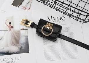 Close-up of a stylish black leather mini belt bag featuring a round gold ring accent