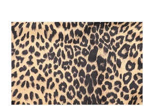 Macro view of leopard print fabric texture featuring brown spots on beige canvas material