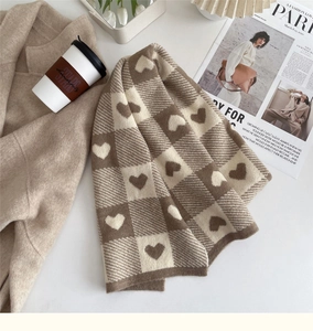 Detail of soft heart checkered knit scarf in coffee brown with cozy winter accessories
