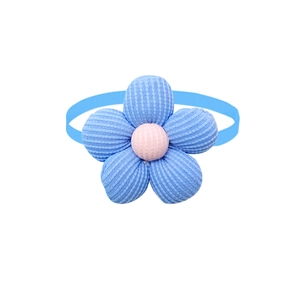 Detailed view of a blue and pink knitted flower bowtie for pet grooming decoration