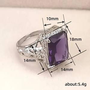 Vintage silver ring with rectangular purple gemstone and hollow pattern details
