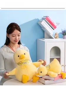 Two yellow plush duck toys in large and small sizes with floral scarves in a home setting
