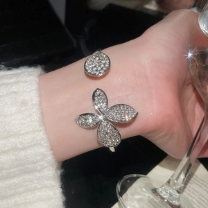 Detailed view of an open cuff bracelet with sparkling crystal-set butterfly design