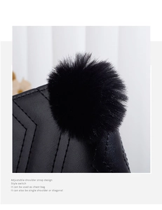 Detail of black wave embroidered wallet with plush pompom and adjustable strap design