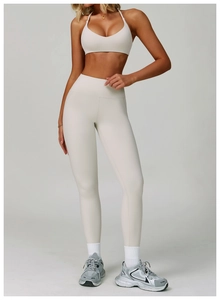 Front view of women's backless sports set including halter neck bra and high waist leggings