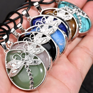 Close-up of assorted dragonfly natural stone pendants with intricate hollow metal layers