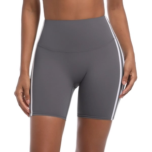 Close-up of grey high-waisted yoga shorts with side stripes and breathable fabric