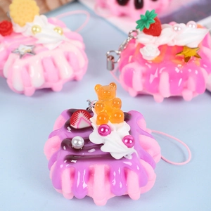 Pink waffle keychain with cream topper, gummy bear, and strawberry cake charm
