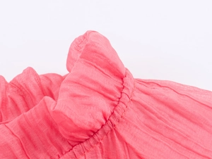 Detailed macro view of pink pleated fabric texture with ruffled elastic edge