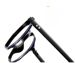 Detail of black polygon eyeglass frame featuring metal rivets and blue light blocking lens