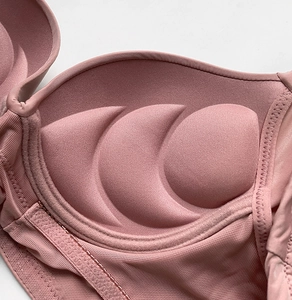 Close-up of pink breathable mesh lining and push-up padded cups for women bra