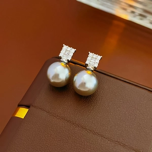 Detail of luxury silver needle pearl earrings with brilliant zircon geometric inlay decoration