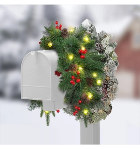 Outdoor Christmas mailbox swag with artificial pine needles, red berries and warm LED lights