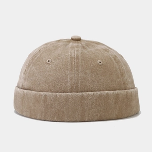 Close-up of vintage khaki docker hat featuring washed cotton texture and brimless design