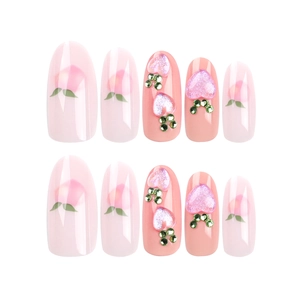 Pink peach press-on nails with 3D heart gems and hand-painted leaf designs