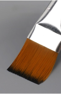 Macro shot of premium nylon bristles with orange-brown gradient and flat brush head design