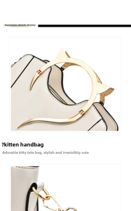 Detail of a creamy white leather handbag with a unique gold cat-shaped metal handle