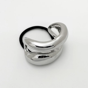 Detail of silver sculptural metal hair ring with black elastic for ponytail styling