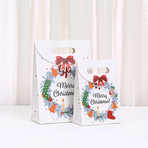Christmas paper gift bags with red bows and Merry Christmas print in multiple sizes