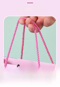 Detailed close-up of durable pink braided nylon handle on a children's cartoon gift bag