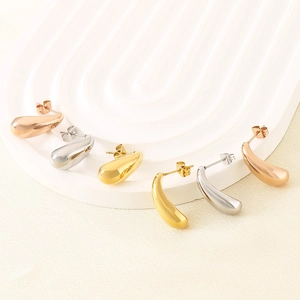 Detailed macro view of minimalist hollow teardrop earrings in gold, silver, and rose gold