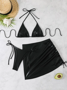 Detailed view of black metallic 3-piece bikini set with drawstring skirt on marble