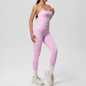 Detail of pink seamless yoga set featuring thin strap top and high waist leggings