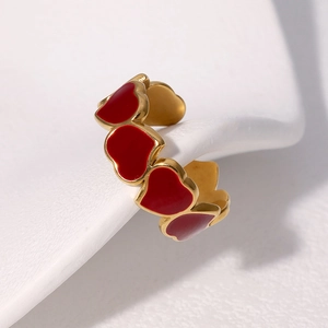 Golden stainless steel open ring with multiple red enamel heart elements on white stone