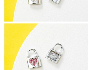 Detailed macro of silver lock pendants with pink heart zirconia and clear stones