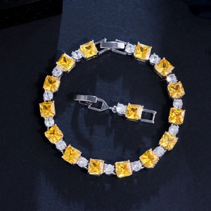Detailed view of yellow square cut gemstone bracelet with silver base and extra clasp