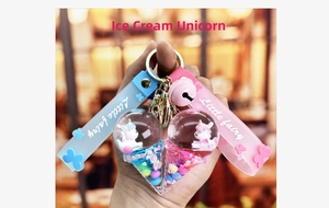 Detail of creative ice cream unicorn keychains with floating glitter and liquid charms