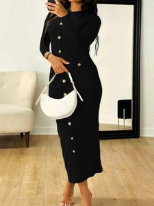 Detailed close-up of a black knit midi dress featuring decorative gold buttons on the front