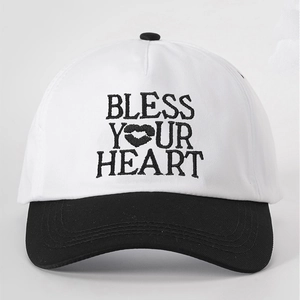 Close-up of BLESS YOUR HEART embroidery and lip graphic on a cotton baseball cap