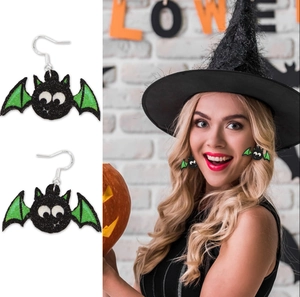 Detail of glittery bat earrings for Halloween party featuring black and green accents